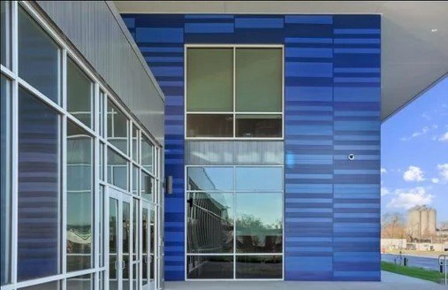 Project Gallery Commercial building entrance with blue metal panel cladding accents