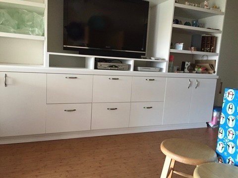 Project Gallery White built-in entertainment center with TV surround and storage drawer bank