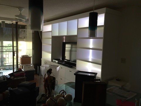 Project Gallery Accent-lit custom white built-in wall unit shown in evening lighting
