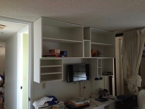 Project Gallery Floating white built-in media wall with open shelving above a wall-mounted TV