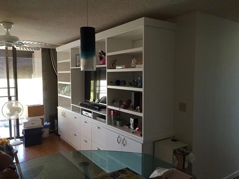 Project Gallery Living room white built-in wall unit with glass display doors and pendant lighting