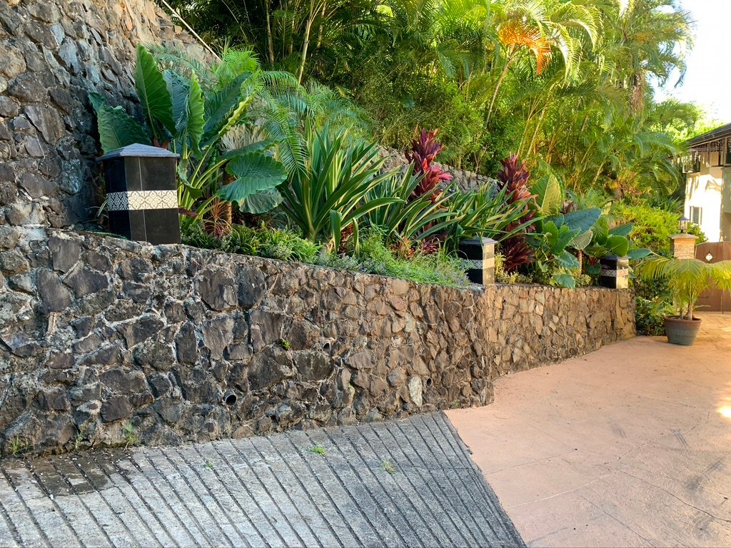 Project Gallery Stacked stone wall installation with accent lantern pier