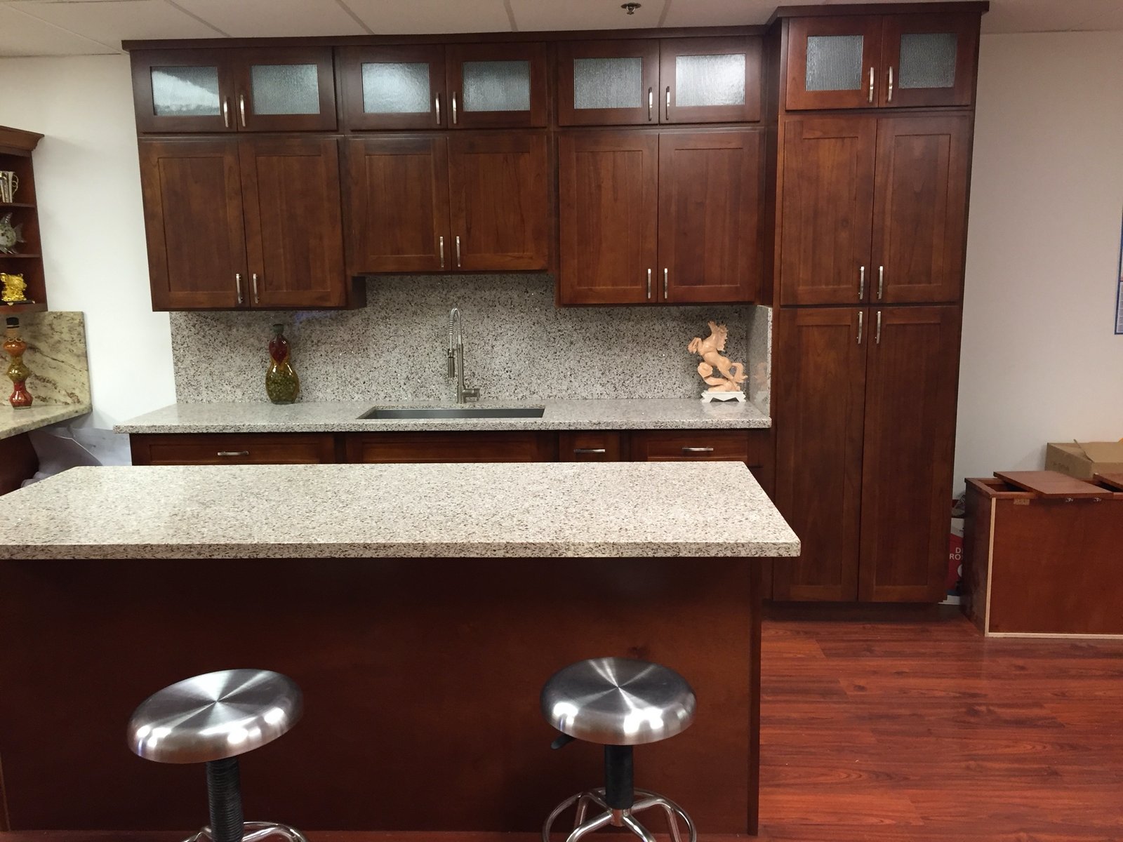 Project Gallery Cherry shaker kitchen cabinetry suite with granite countertops and island seating