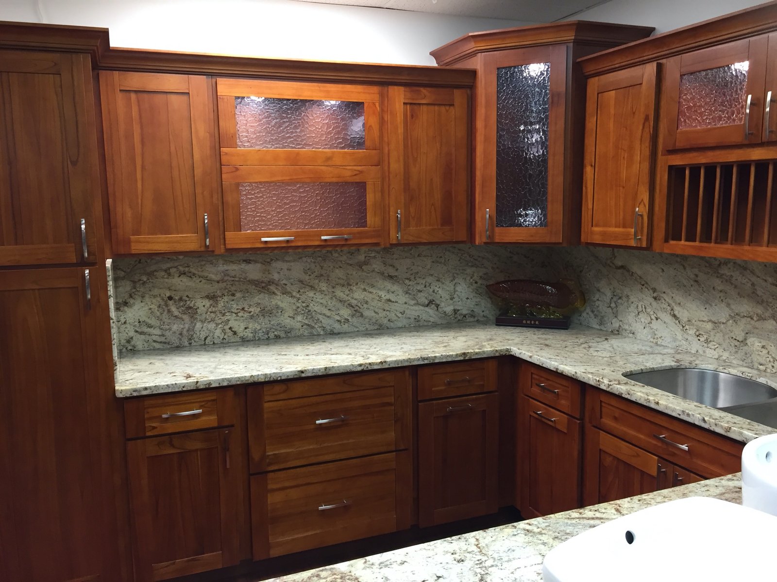 Project Gallery Corner cabinetry detail with textured glass inserts and wood accents