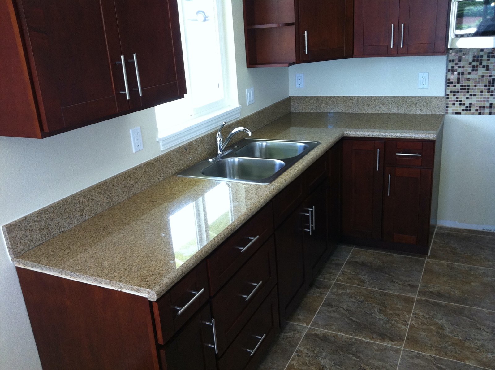 Project Gallery L-shaped granite countertop with stainless double-basin sink and cherry cabinetry