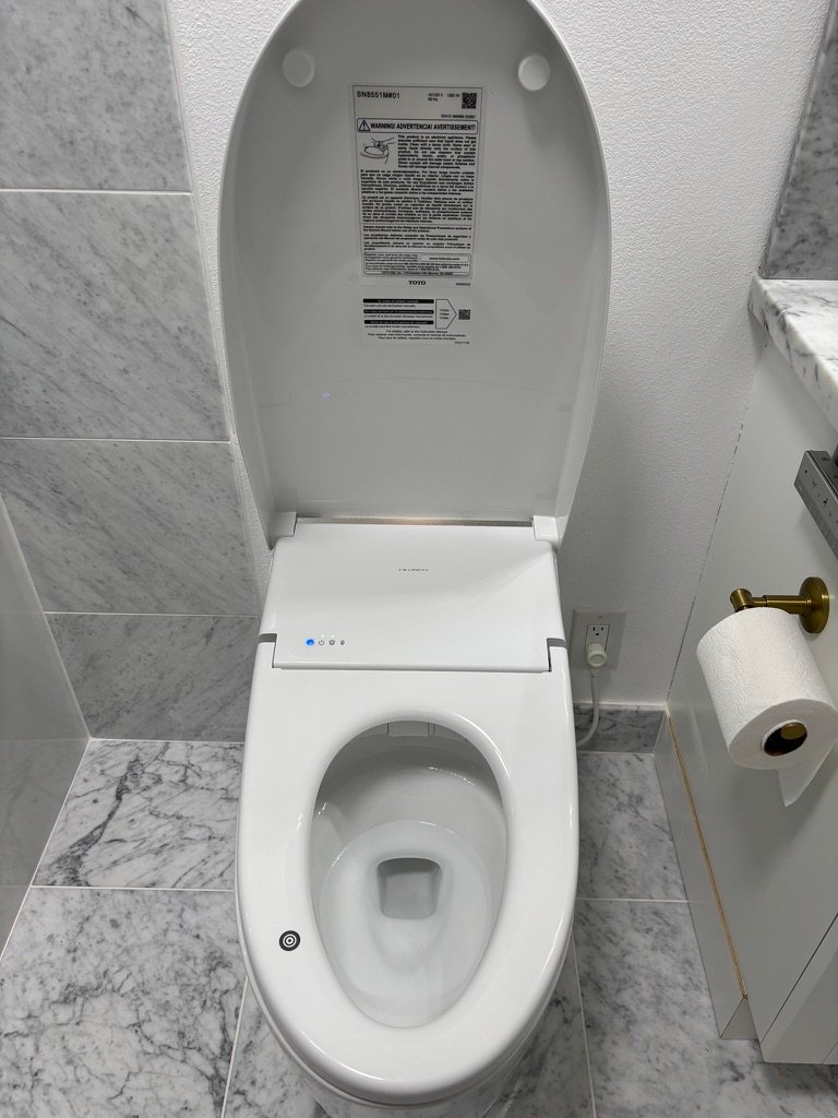 Project Gallery Smart bidet toilet with open lid showing heated seat and control detail