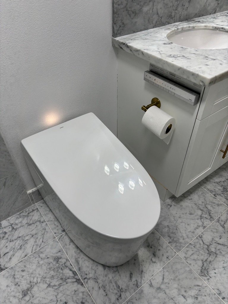 Project Gallery Smart bidet toilet with integrated control panel beside a marble vanity