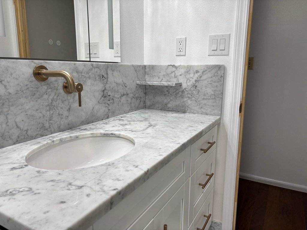 Project Gallery Marble vanity backsplash with a built-in corner niche shelf