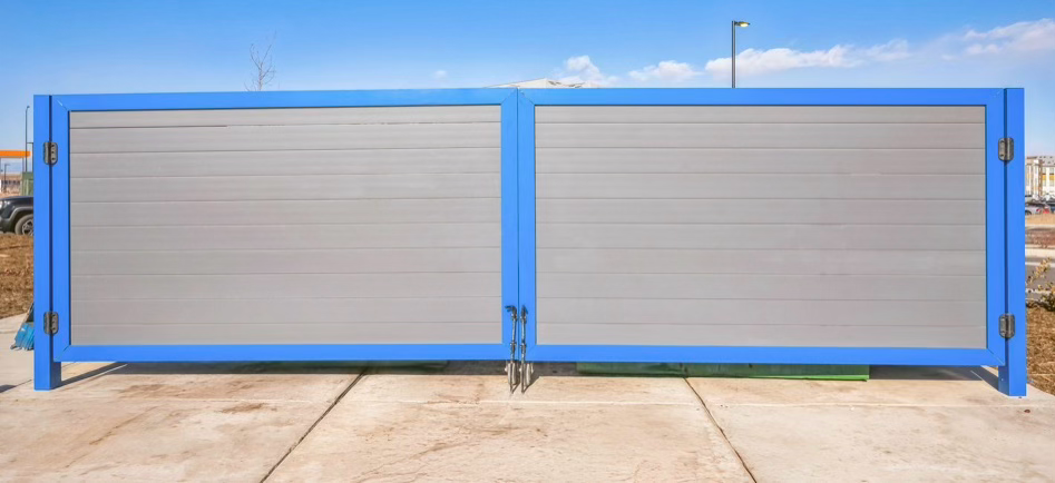 Project Gallery Powder-coated aluminum horizontal slat double swing gate in a blue frame at a commercial yard entry