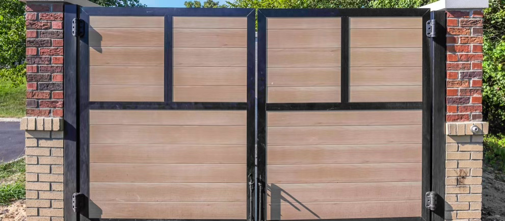 Project Gallery Close detail of a woodgrain aluminum swing gate panel between brick pillars