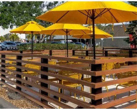 Horizontal aluminum rail screen enclosing an outdoor dining patio