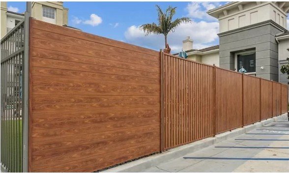 Parallel AP woodgrain aluminum privacy fence with vertical batten screen at a multifamily property