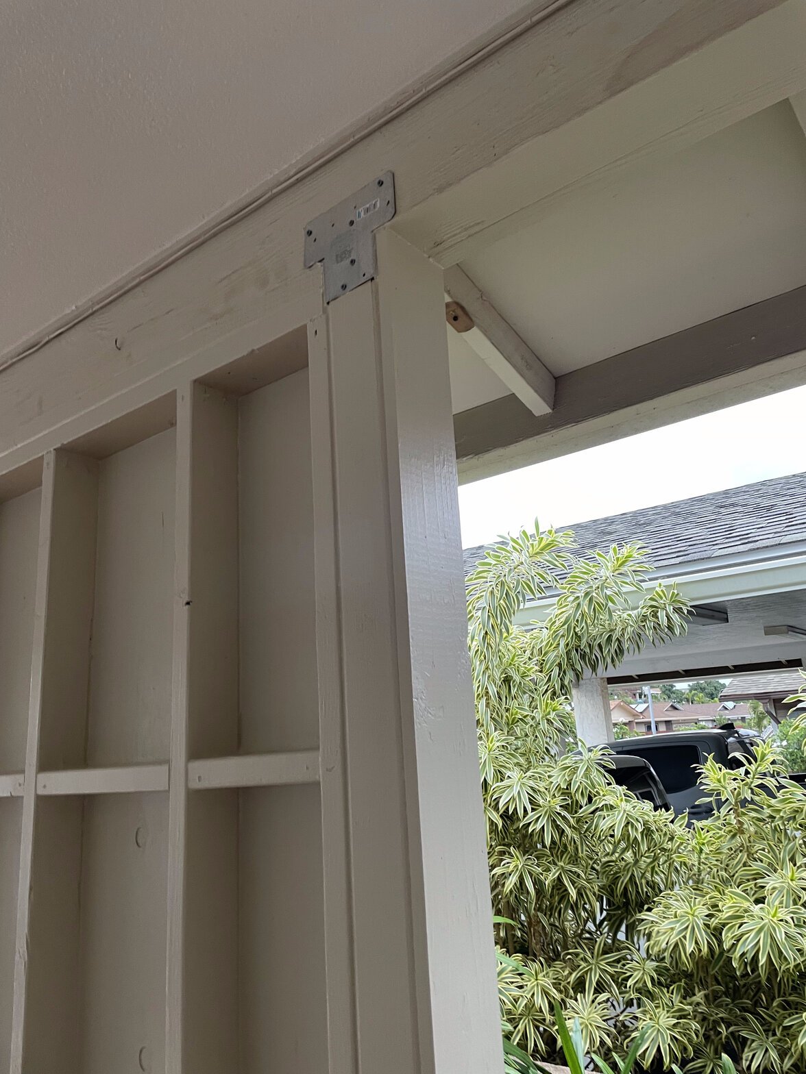 Project Gallery Interior wood framing corner with metal L-bracket and slotted shelf compartments