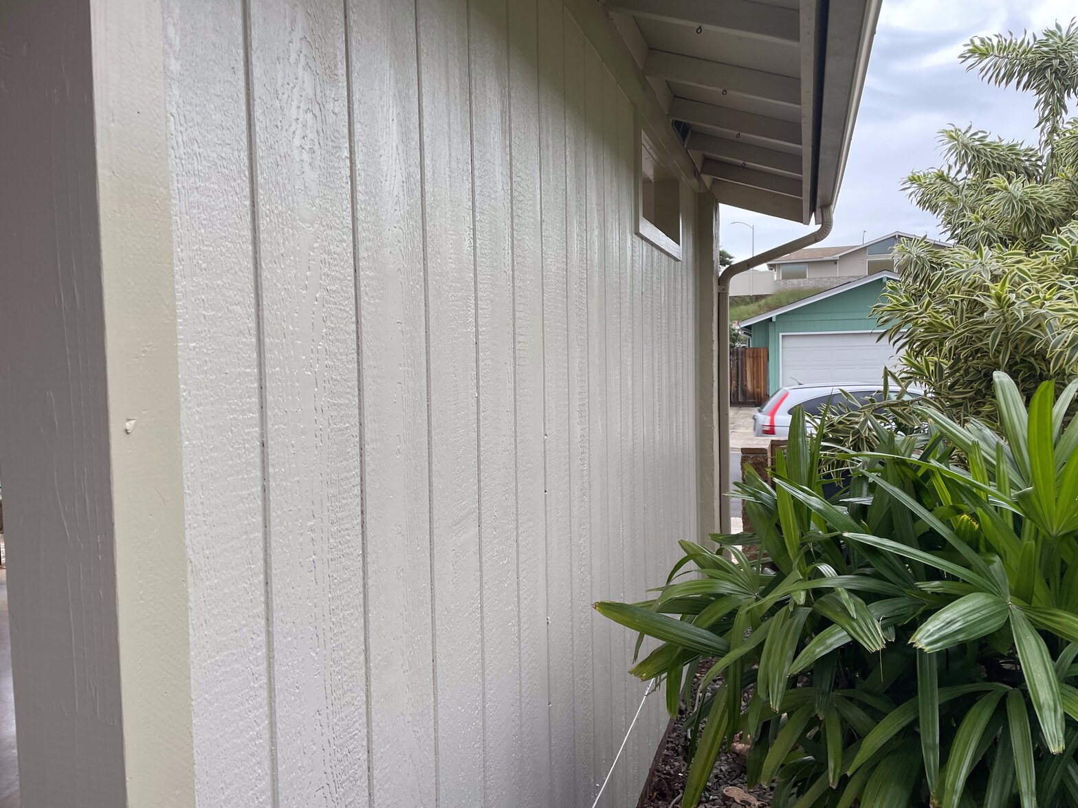 Project Gallery Board-and-batten exterior enclosure wall matched to home siding with vent and gutter