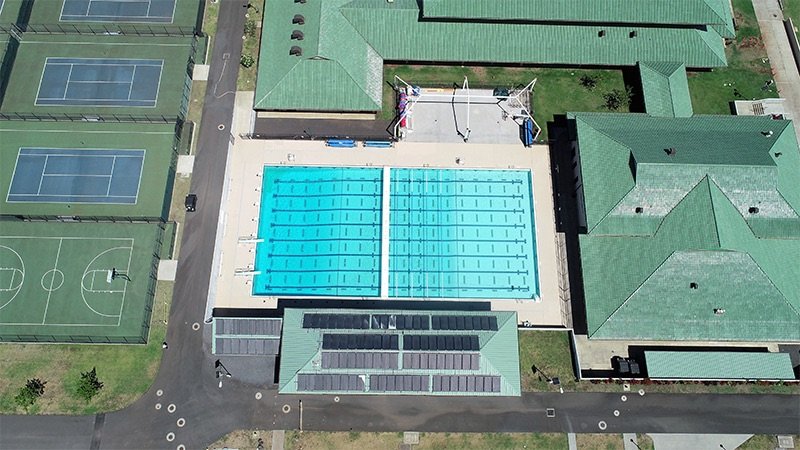 Project Gallery Aerial view of competition swimming pool complex with adjacent courts